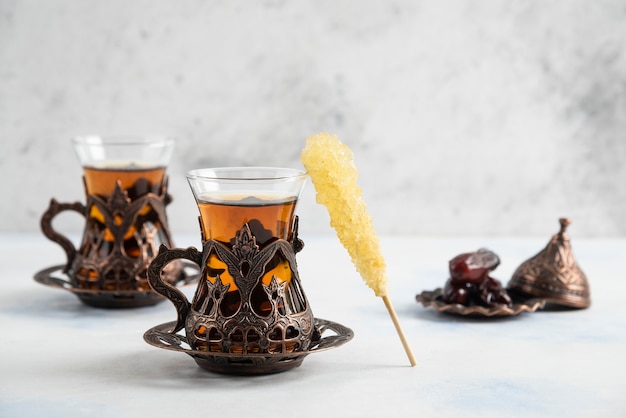 Fragrant Turkish tea on white surface