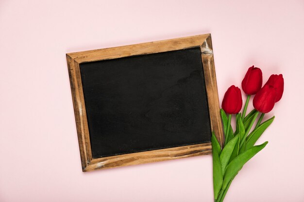 Frame beside bouquet of tulips