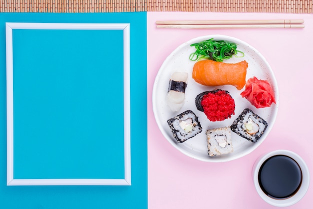 Free photo frame beside plate with sushi