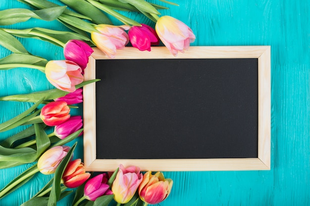 Frame blackboard around bouquet of tulips