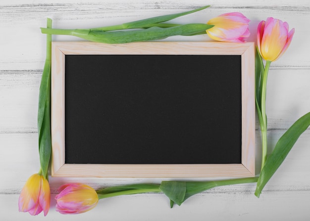 Frame blackboard around tulips