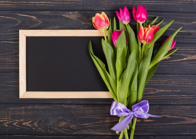 Frame chalkboard with bouquet of tulips