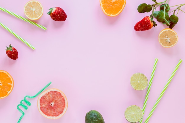 Frame of citrus fruits and strawberries 