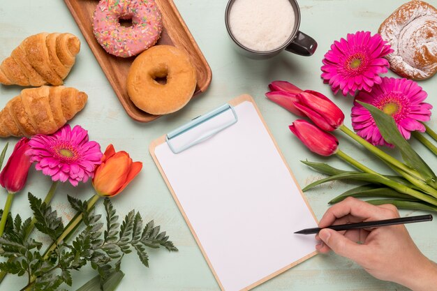 Frame clipboard with hand writing and breakfast set