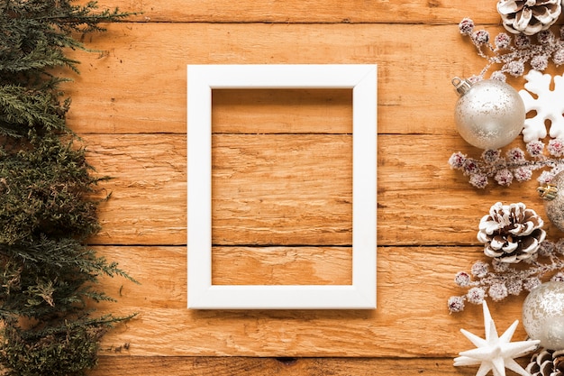 Free photo frame between coniferous twigs and christmas toys