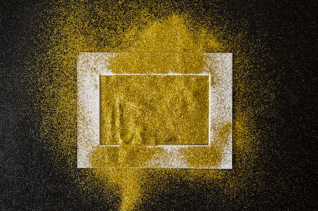 Free photo frame covered with yellow sequins on table