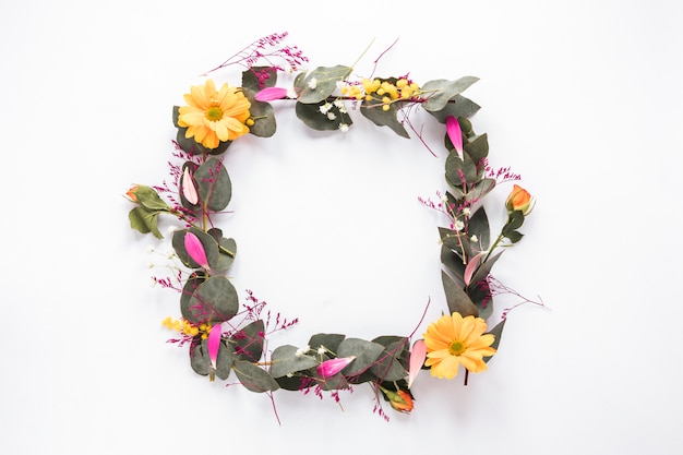 Frame of fresh flowers with green leaves on twigs