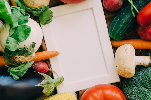 Free photo frame on fresh vegetables