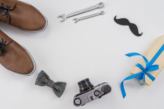 Frame from tools, camera and man shoes on table