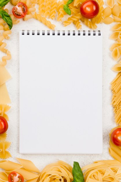 Frame of italian pasta with notebook