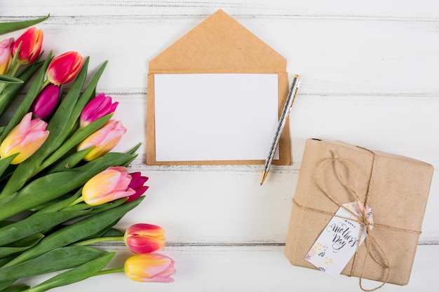 Frame letter around gift box and tulips 