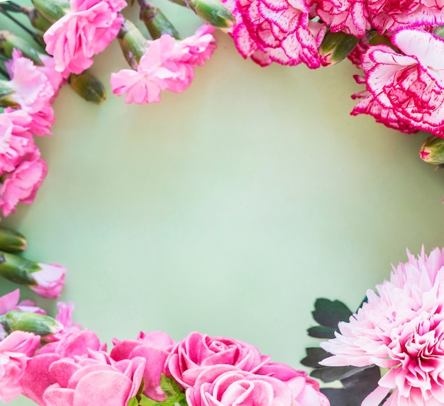 Frame made from pink flowers on table 