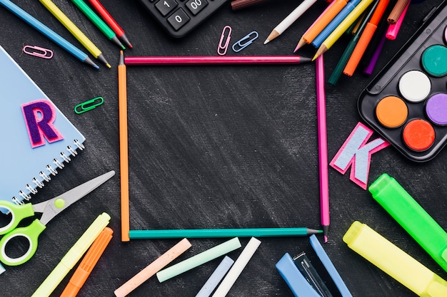 Frame made of stationery over chalkboard