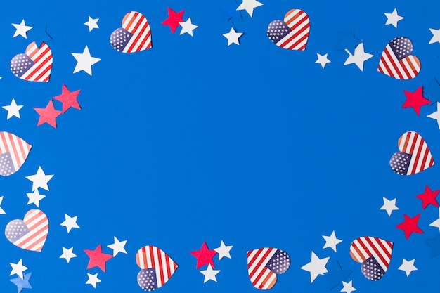 A frame made with heart shape american flags and stars for writing the text on blue background