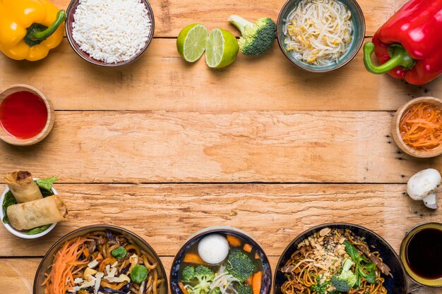 Frame made with traditional thai food with vegetables on wooden desk