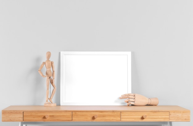 Free photo frame mock up on table beside human body