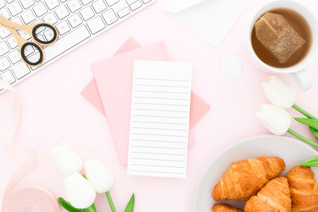 Frame of office tools and croissant for breakfast