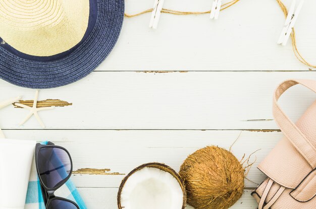 Frame of panama hat, sunglasses and coconut