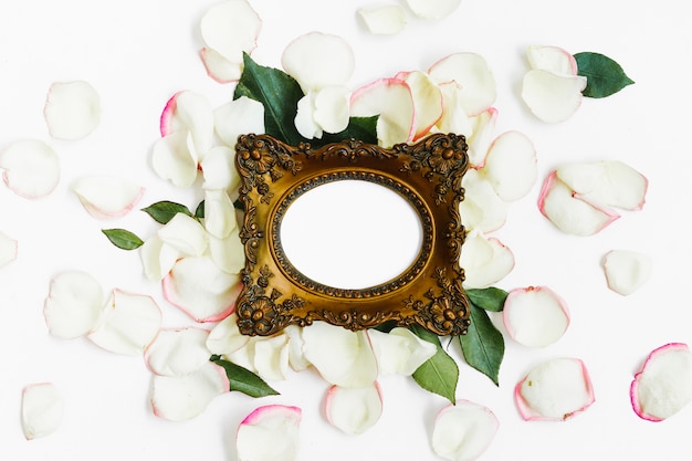 Free photo frame surrounded by rose petals