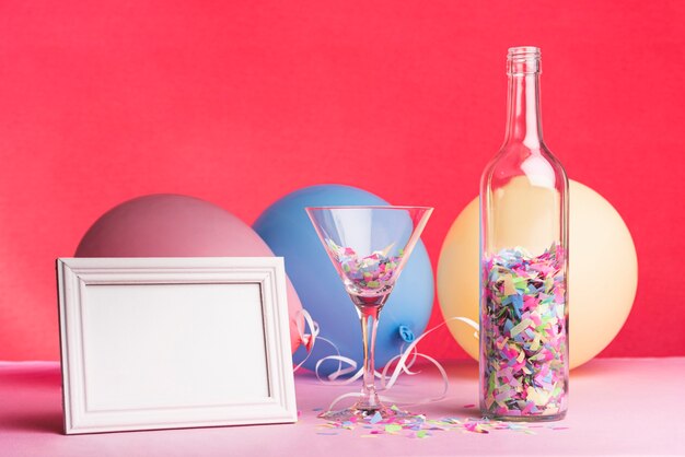 Frame with balloons and glass on a red background