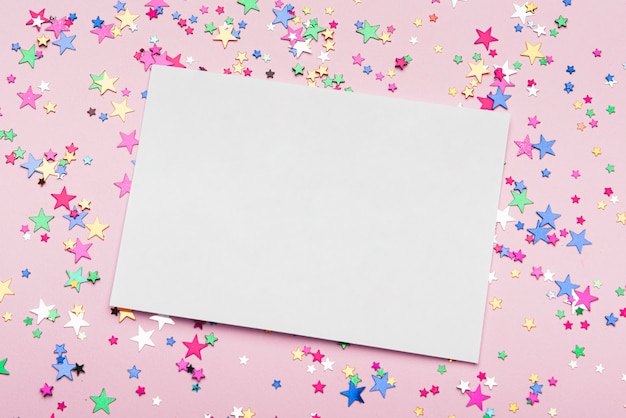 Frame with colorful confetti stars on pink background