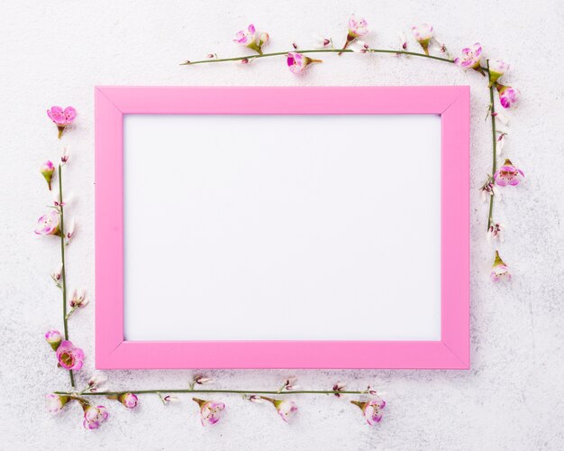 Frame with flowers beside