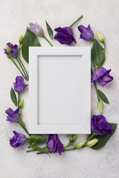 Free photo frame with flowers on table