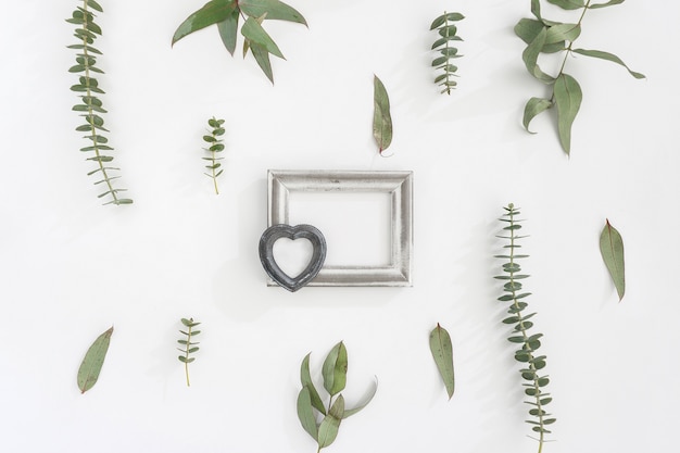 Frame with heart on floral wall