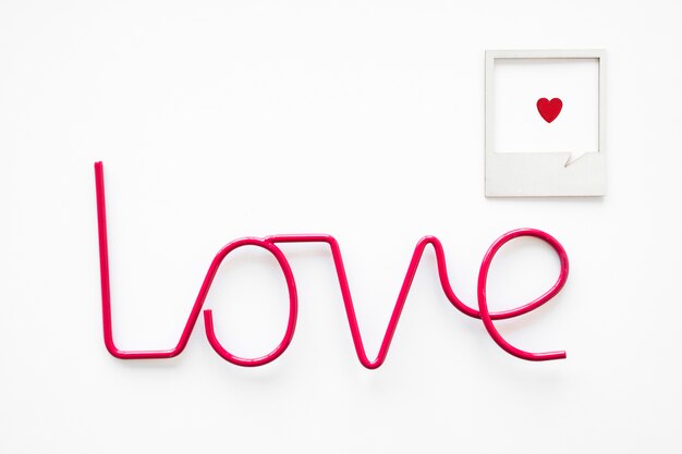 Free photo frame with heart near love writing