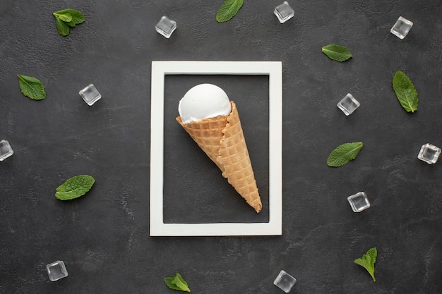 Frame with ice cream on cone inside and ice cubes