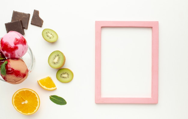 Free photo frame with ice cream cup in glass with fruits