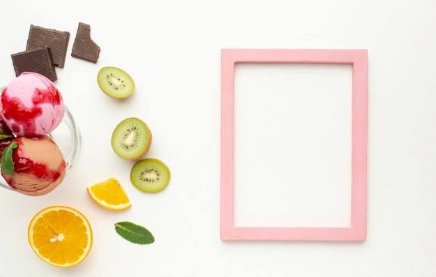 Frame with ice cream cup in glass with fruits