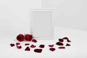 Free photo frame with red roses on white table