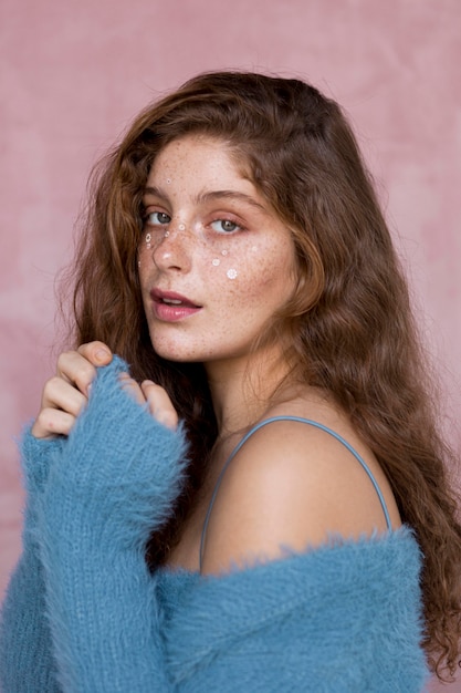 Freckled woman with white flowers on her face