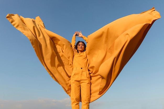 Freedom concept with woman holding cloth in nature