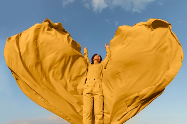 Freedom concept with woman holding cloth in nature