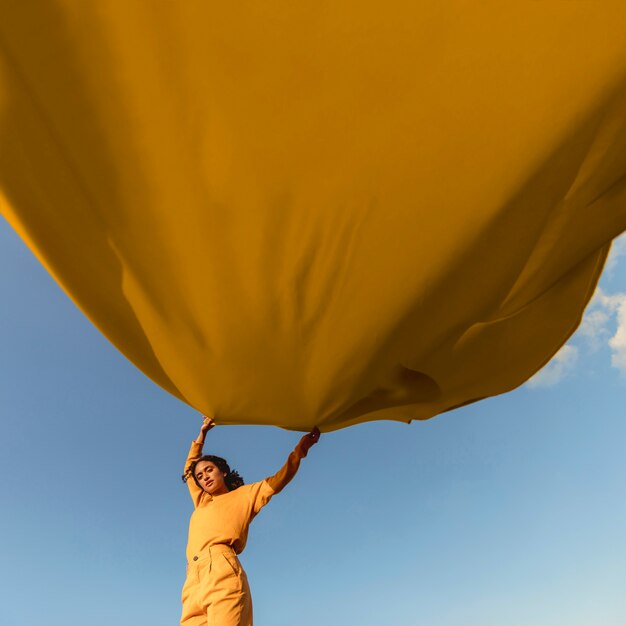 Freedom concept with woman holding cloth in nature