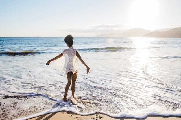 Free photo freedom concept of woman walking in water