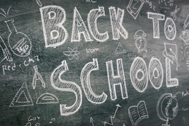 Free photo freehand drawing back to school on chalkboard