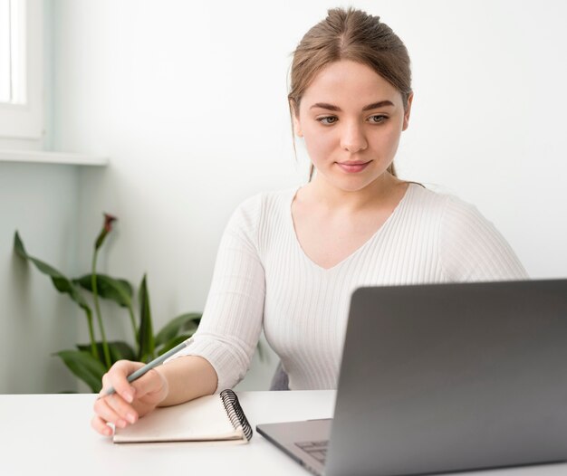 Freelance female at desk writing in agenda