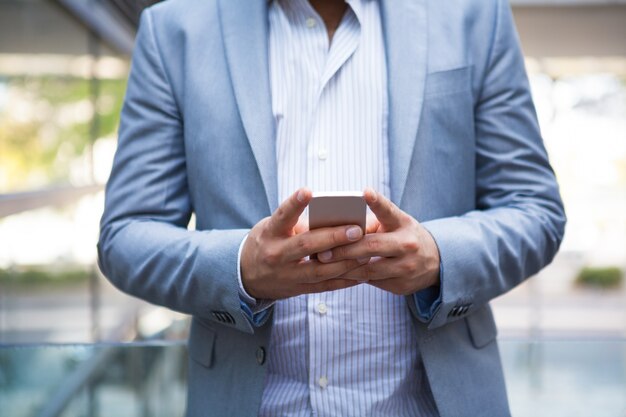 Freelance manager texting message on smartphone