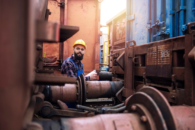 Free photo freight cars inspection and cargo dispatching at train station