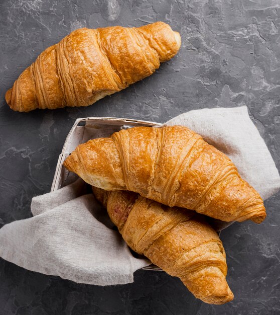 French croissants in cardboard box and cloth