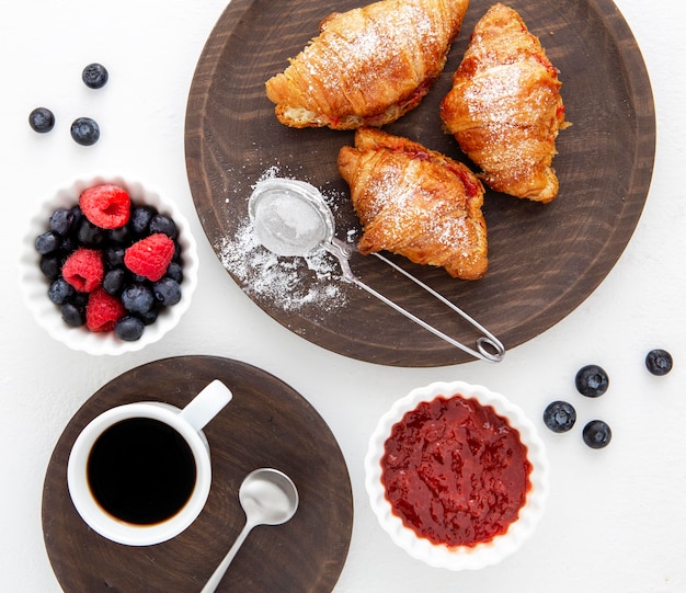 Free photo french croissants and forest fruit jam