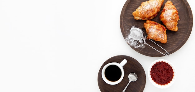 French croissants and strawberry jam flat lay