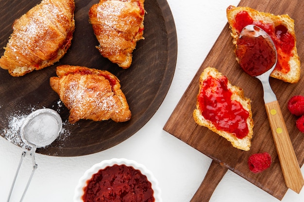 Free photo french croissants and strawberry jam