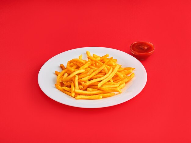 French fries on a plate on red