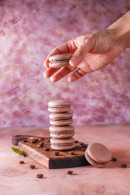 Free photo french macaroons with coffee beans.