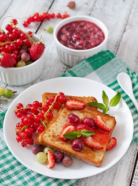 French toast with berries and jam for breakfast