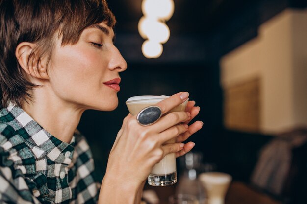 French woman in cafe drinking latte